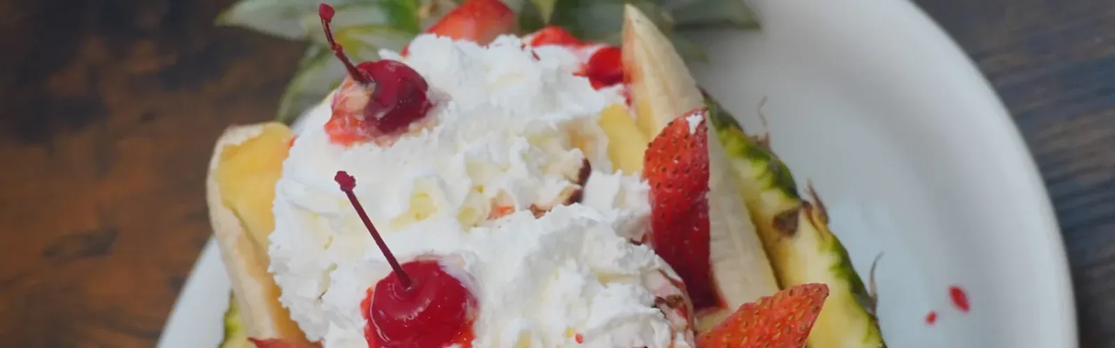 Hawaiian piña colada served in a fresh pineapple with whipped cream at Erica's World's Best Mexican Desserts